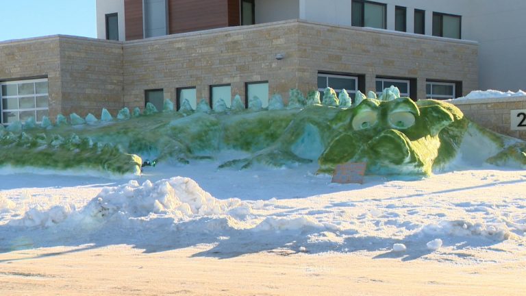 Giant green snow dragon created in Greenbryre area, two dragons in Saskatoon