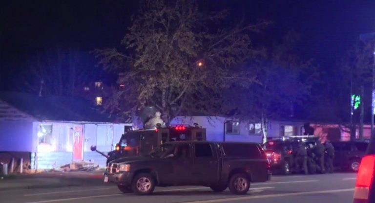 Abbotsford Police remain at scene of stand-off outside bullet-riddled home