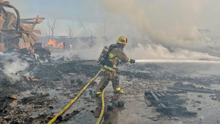 Fire visible across Los Angeles burns commercial yard, buses