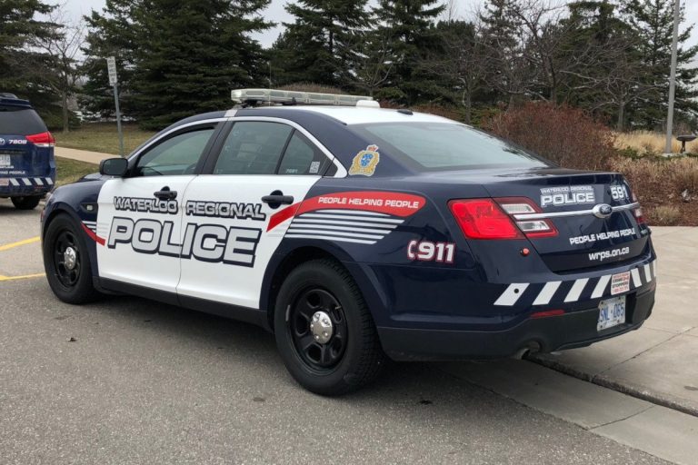 Man arrested, woman sought after vehicle rolls over, hits bus shelter in Kitchener