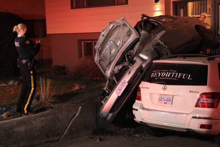 Car lands on top of parked vehicle in Kelowna driveway