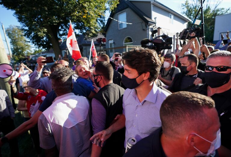 Protesters throw small rocks, debris at Trudeau as he leaves Ontario campaign stop