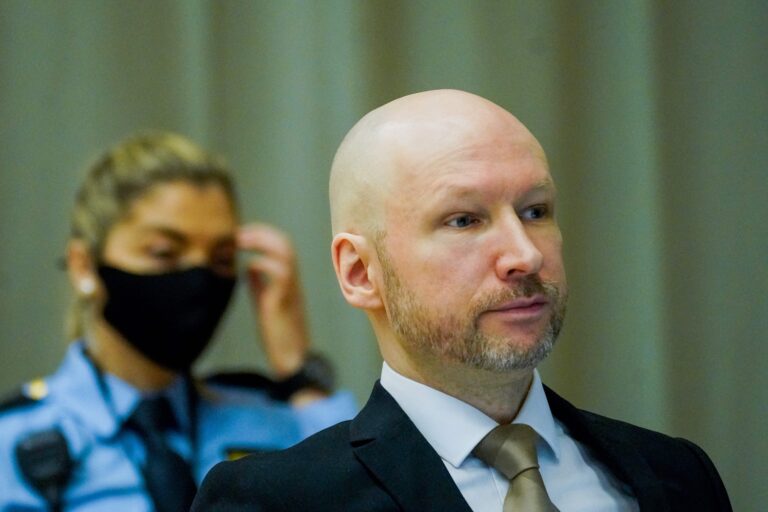 Norwegian mass killer pins white supremacist messages to suit at parole hearing