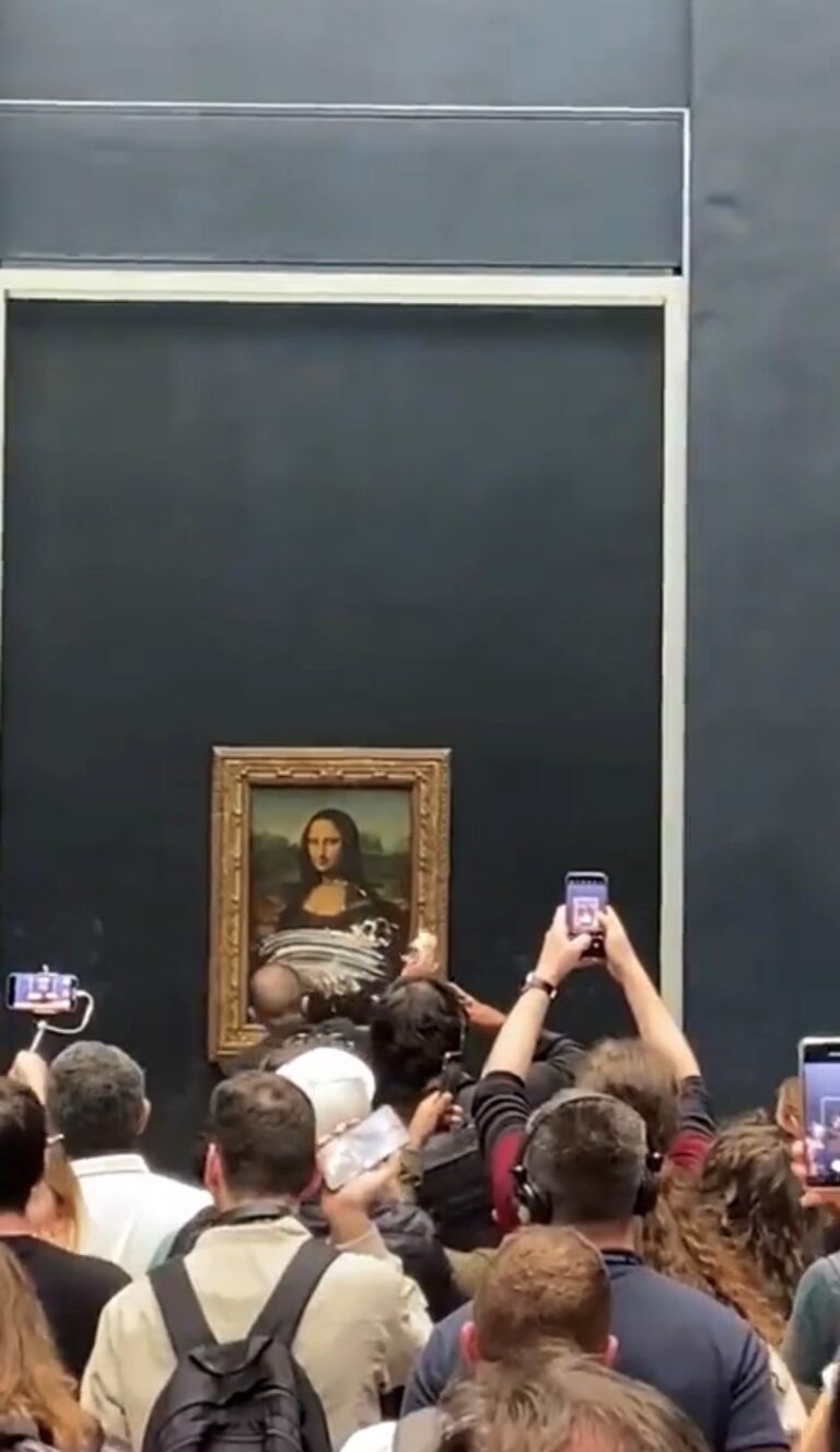Man in disguise throws cake at Mona Lisa painting in Louvre Museum