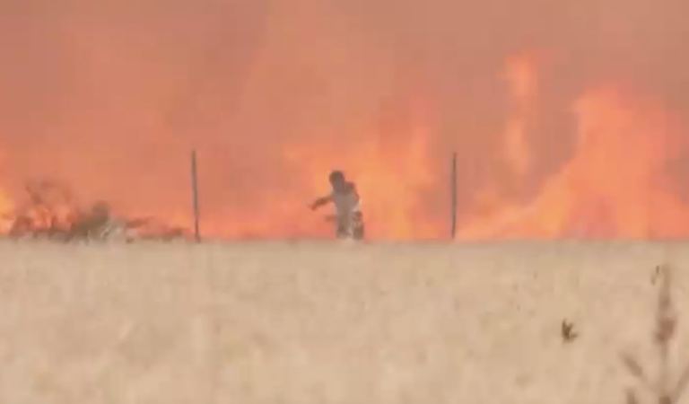 With clothes ablaze, Spanish man filmed barely escaping wildfire