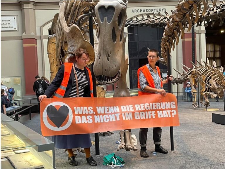 Climate activists glue themselves to dinosaur display in Germany
