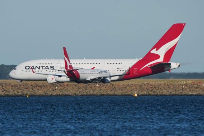 Man charged after allegedly trying to open Qantas plane door mid-flight